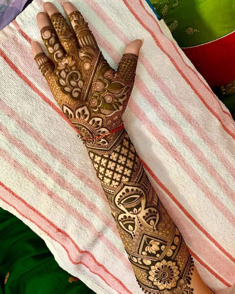 A Girls is Showing Their Hands Bridal Mehndi Design by Henna House- Rajasthani Mehndi Artist in Jaipur.