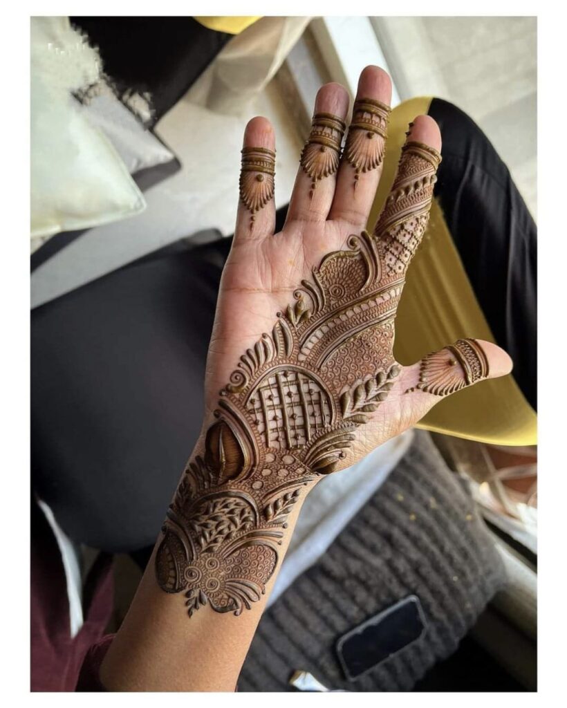 A Girls is Showing Their Hands Gujarati Mehndi Design by Henna House- Gujarat Mehndi Artist in Jaipur.